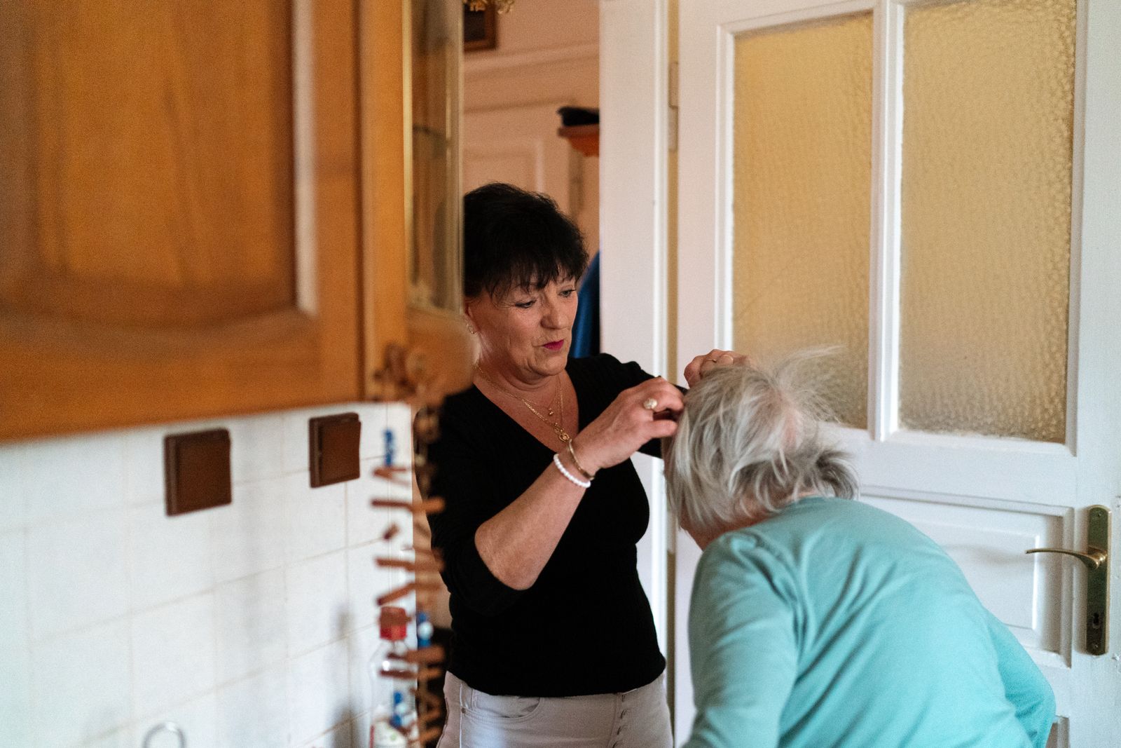 Caregiver helping an older adult during a home health visit